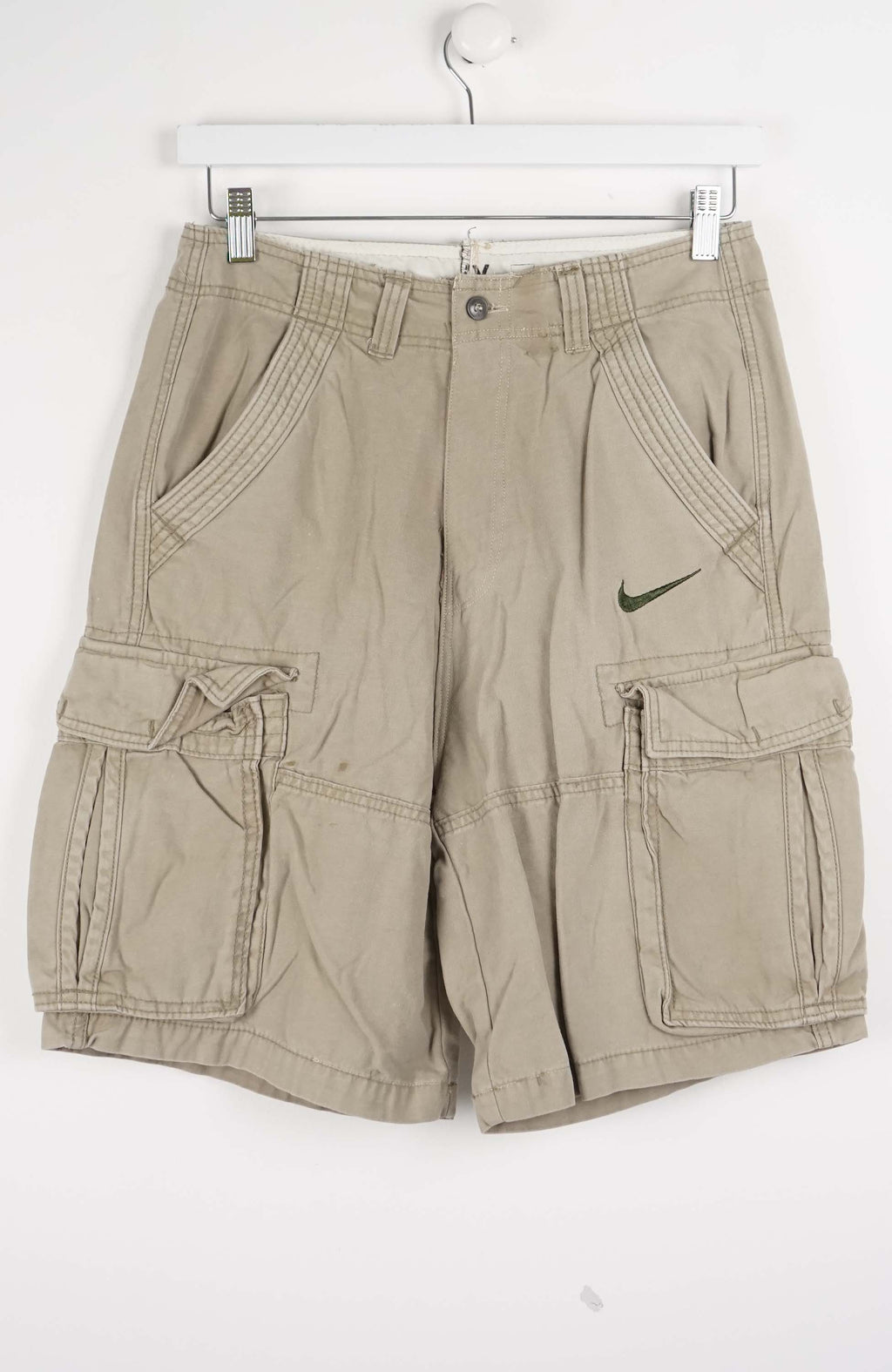 Beige cargo shorts with Nike logo on a white background