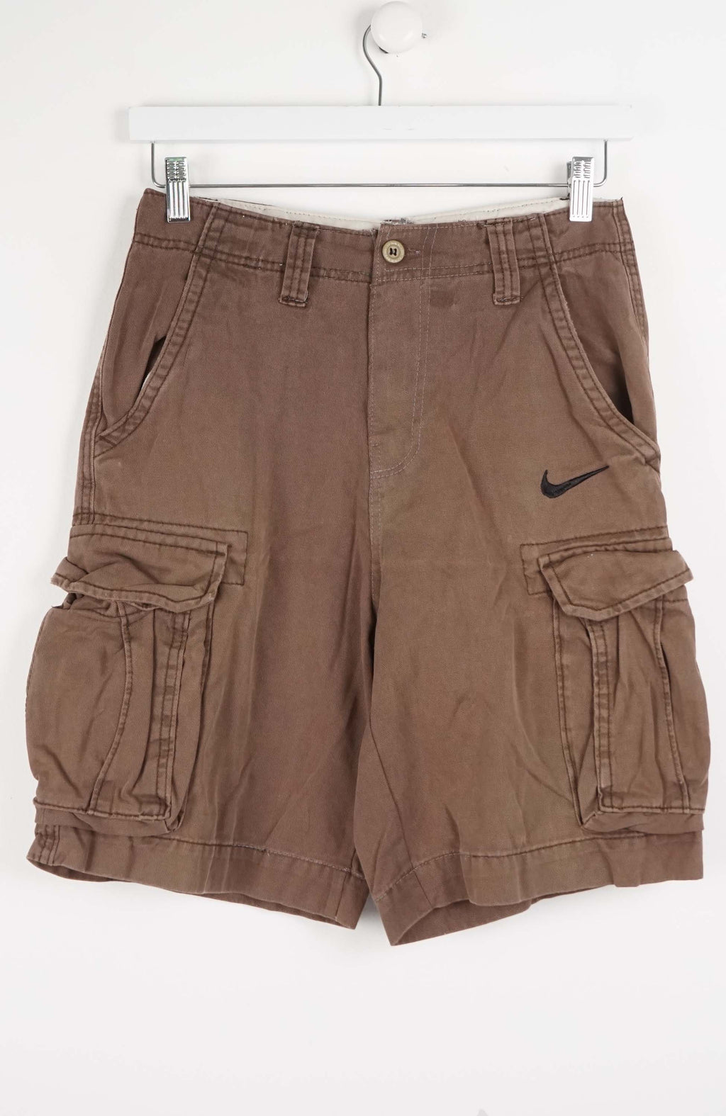 Brown cargo shorts with a Nike logo on a white background