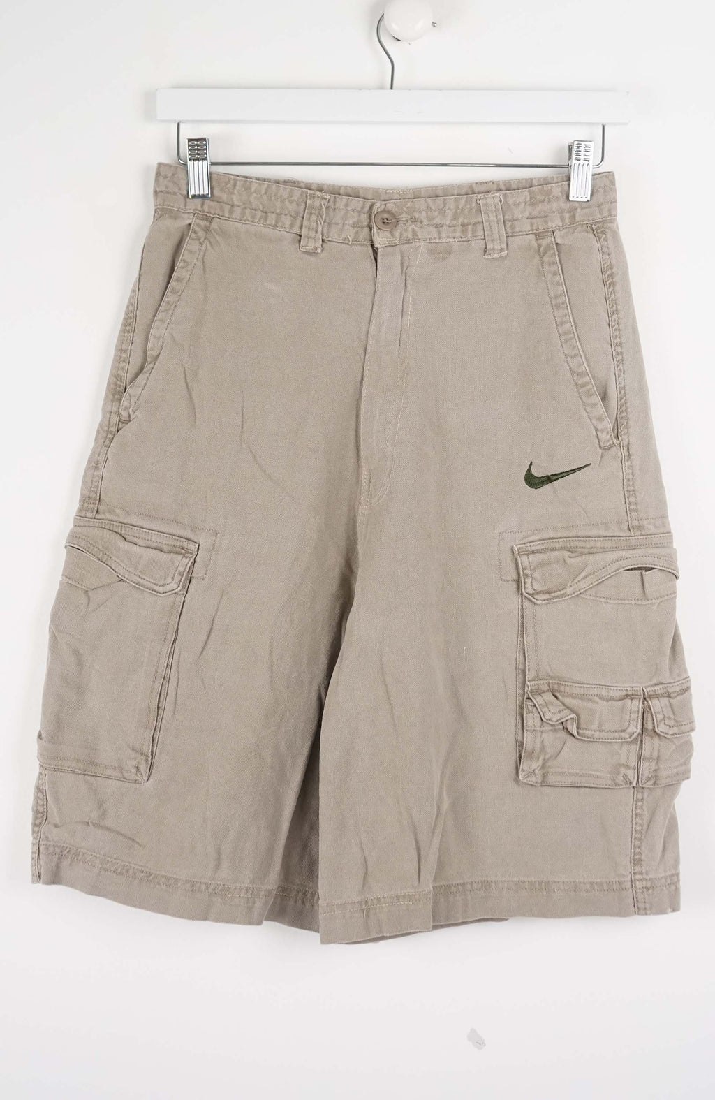 Beige cargo shorts with a Nike logo on a white background
