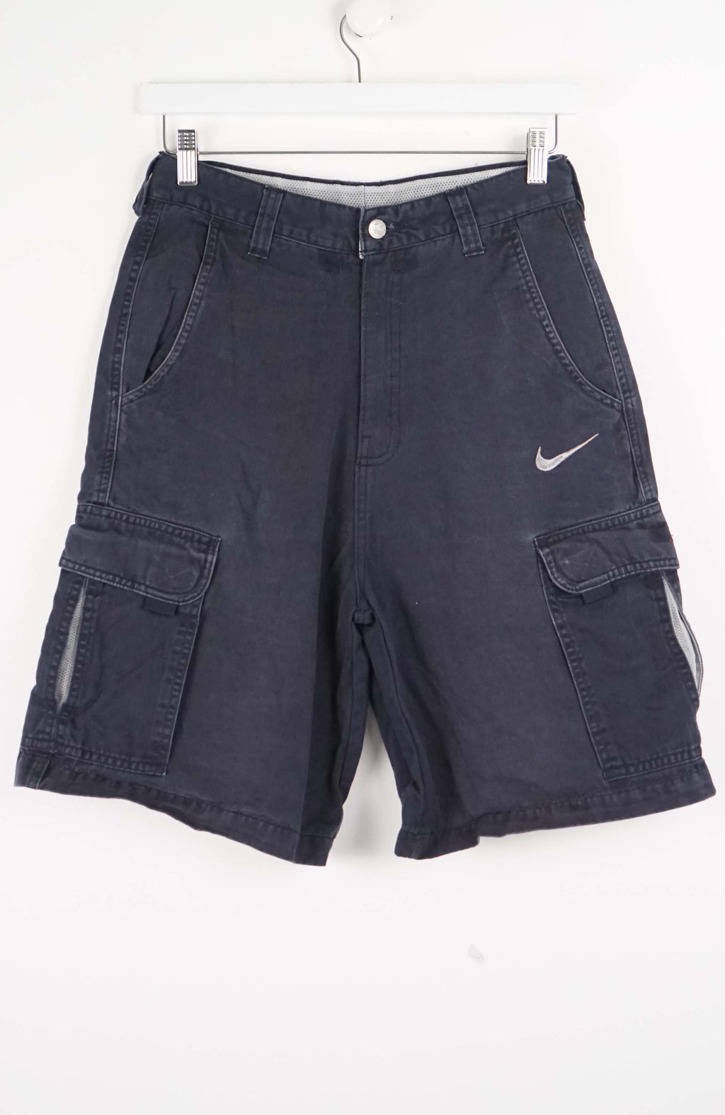 Blue cargo shorts with a Nike logo on a white background