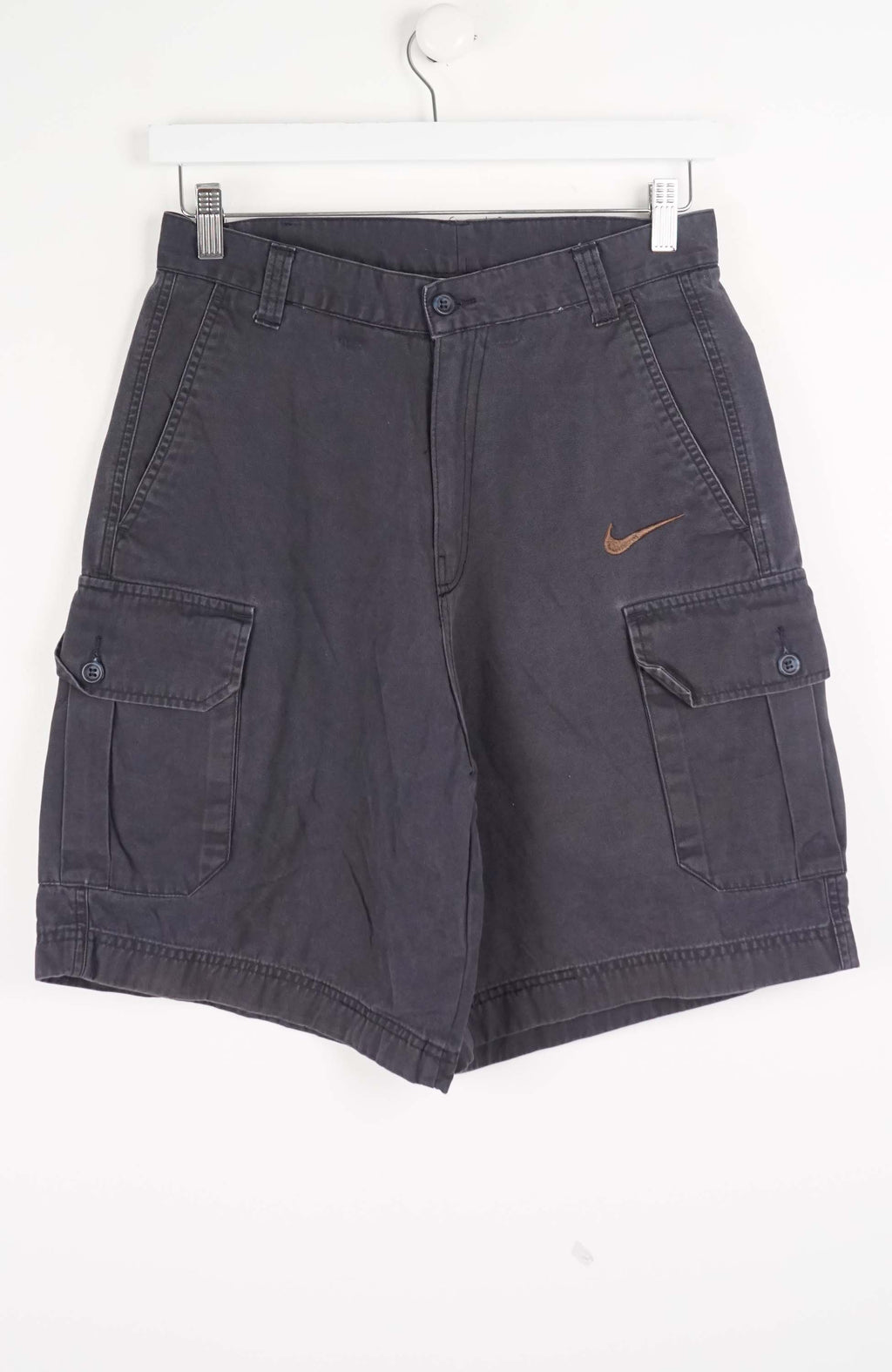 Gray cargo shorts with a Nike logo on a white background