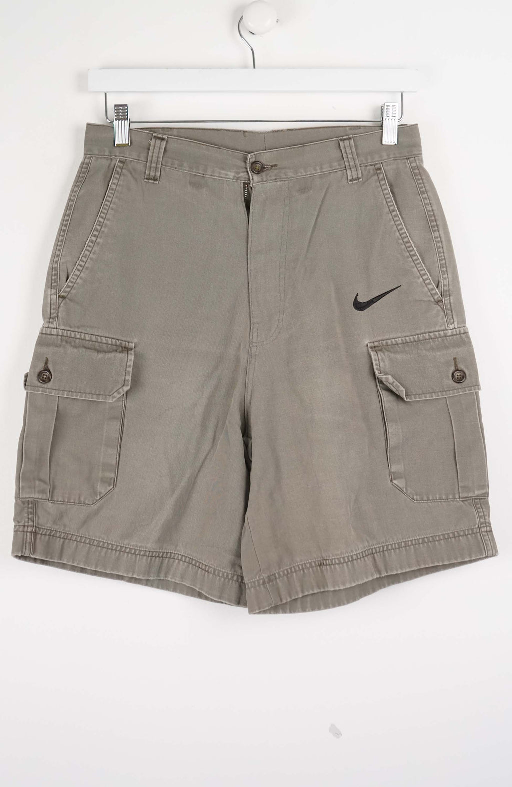 Gray cargo shorts with a Nike logo on a white background