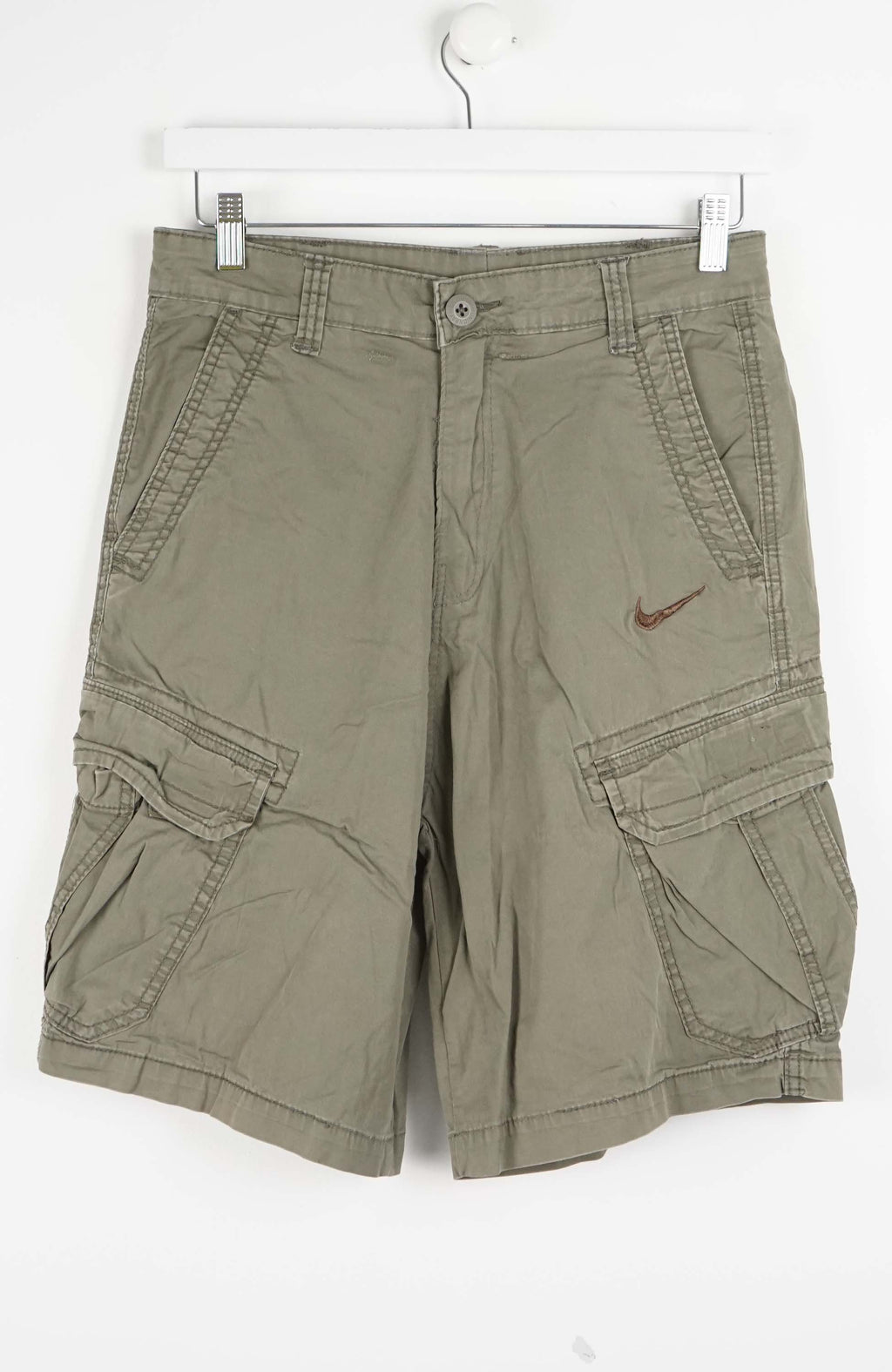 Green cargo shorts with a Nike logo on a white background