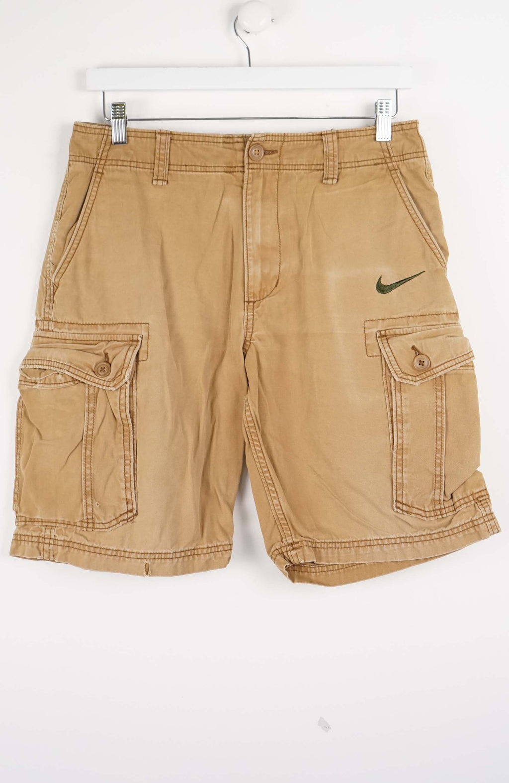 Beige cargo shorts with Nike logo on a white background