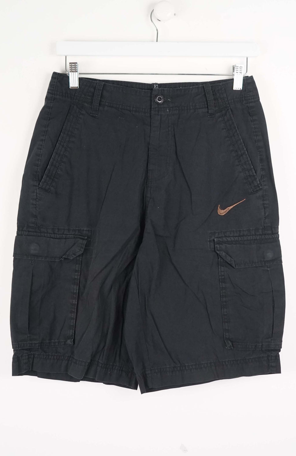 Black cargo shorts with a Nike logo on a white background