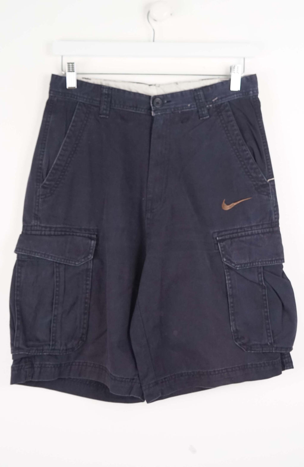 Navy blue cargo shorts with Nike logo on a white background