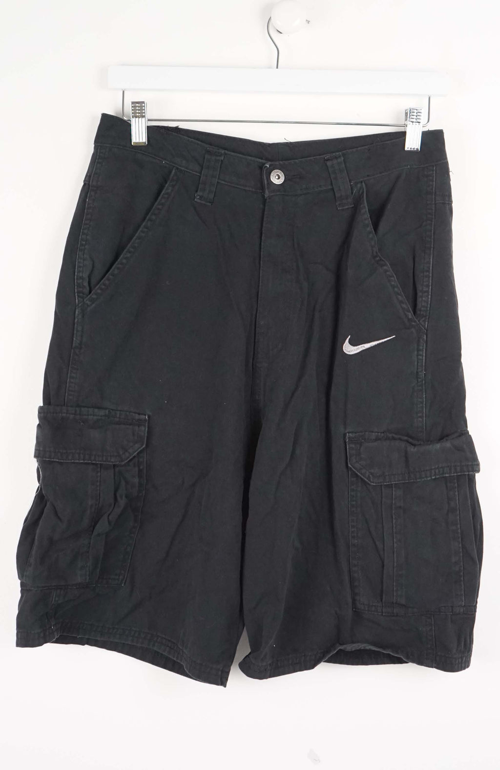 Black cargo shorts with a Nike logo on a white background