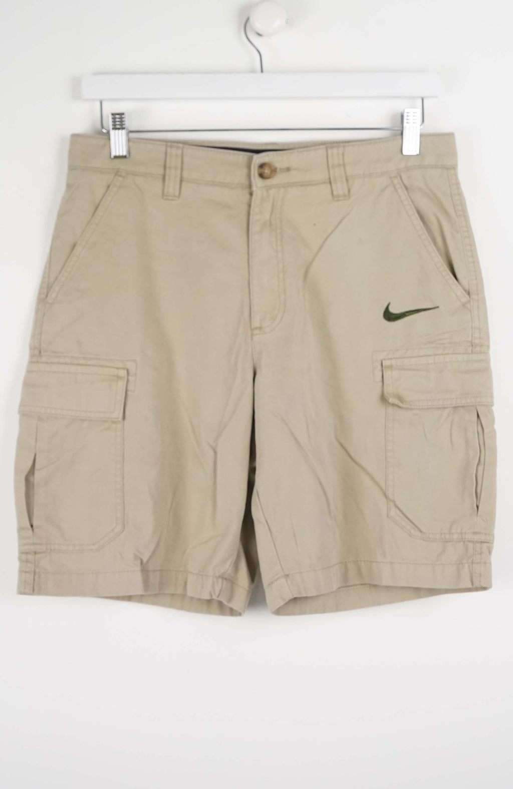 Beige cargo shorts with Nike logo on a white background