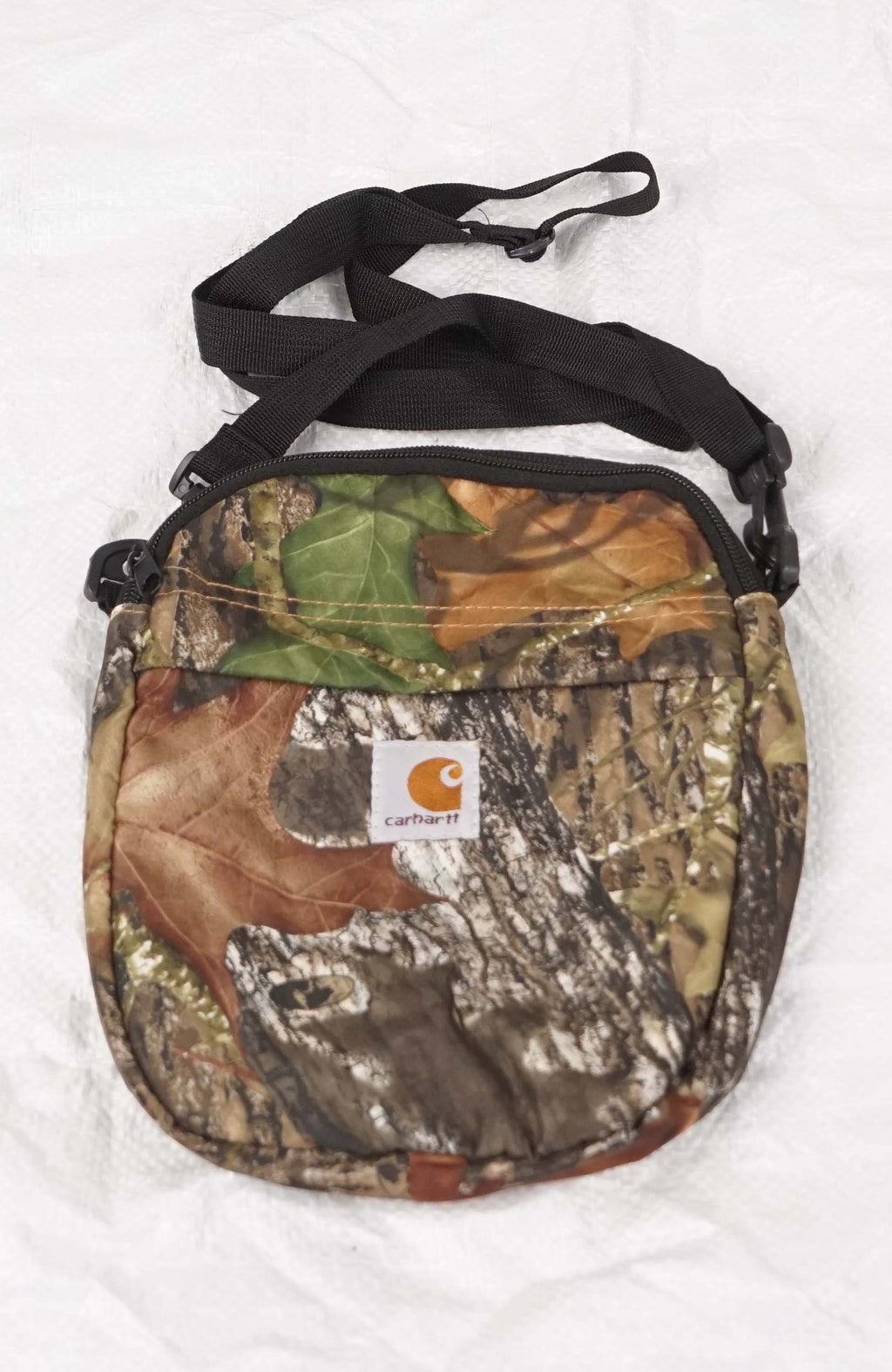 Camouflage crossbody bag with a visible brand logo on a white background