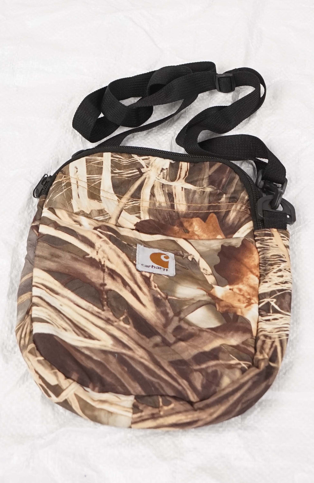 Camouflage crossbody bag with a visible brand logo on a white background