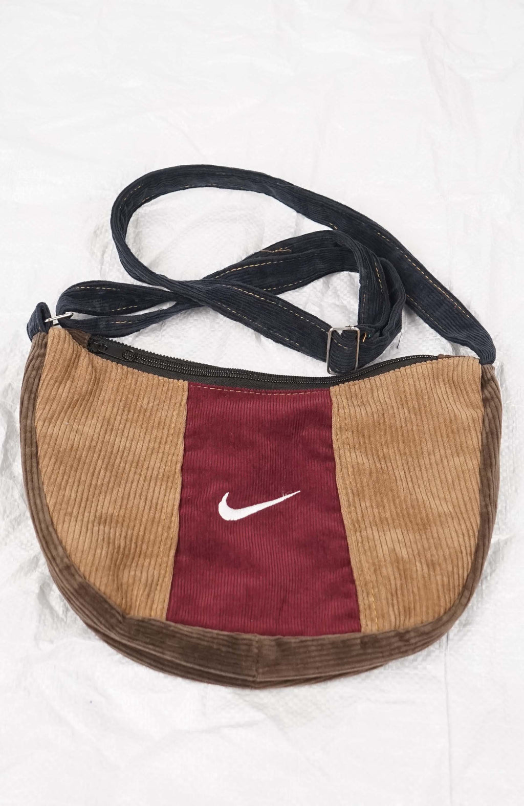 Brown and red bag with Nike logo on a white background