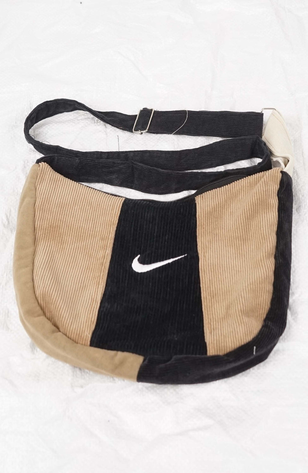 Two-tone corduroy bag with Nike logo on a white background