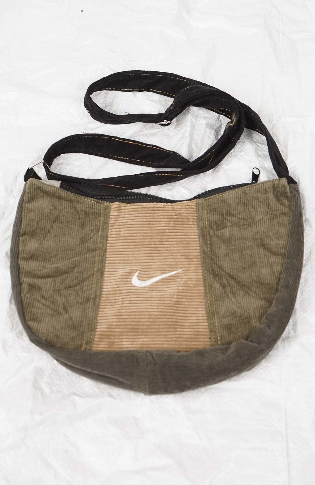Brown corduroy bag with Nike logo on a white background