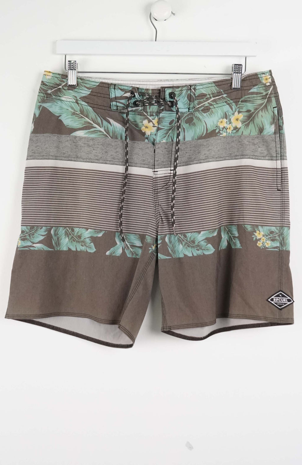 Brown shorts with floral patterns on a white background