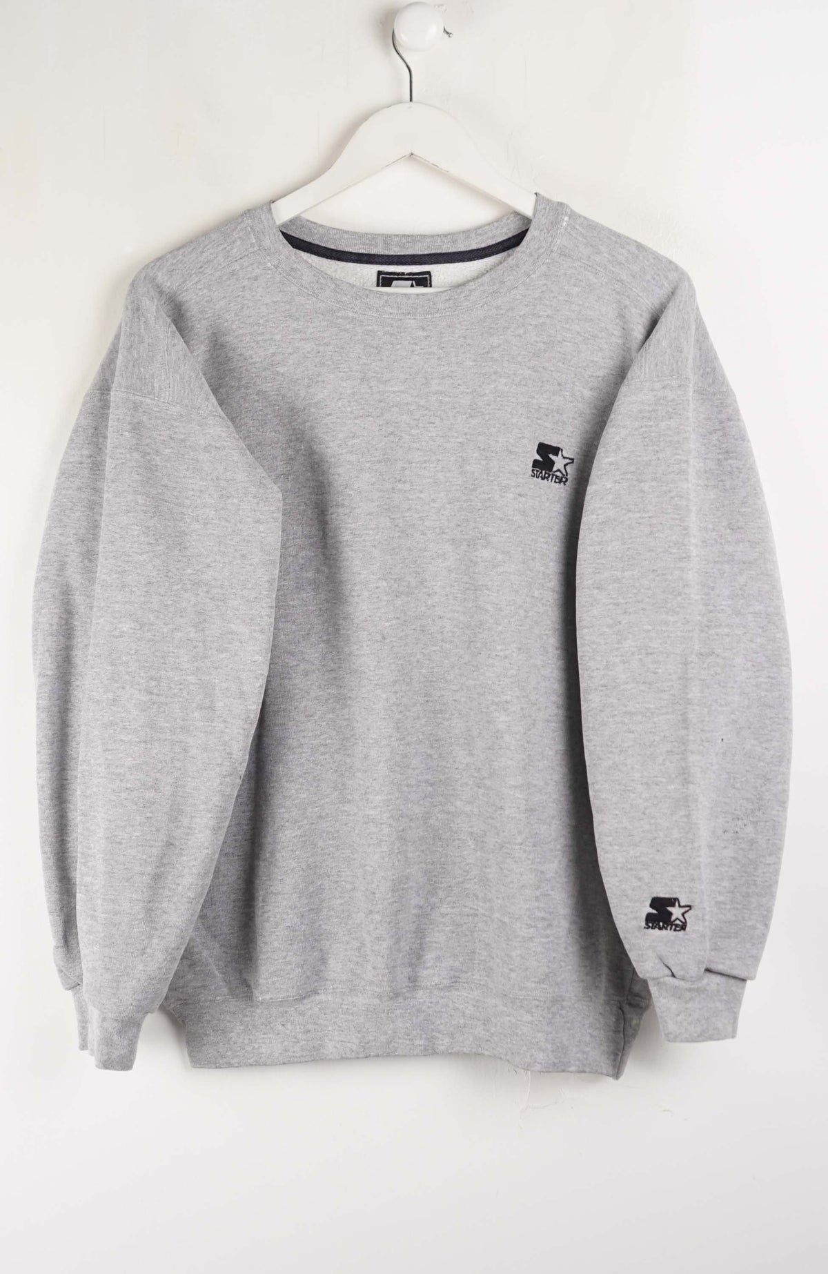 Gray sweatshirt with brand logos on a white background