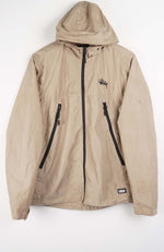 Beige jacket with black zippers on a white background