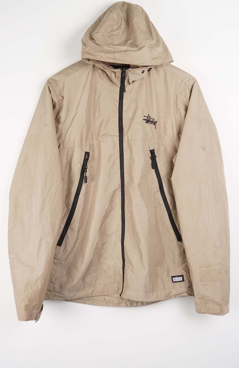 Beige jacket with black zippers on a white background