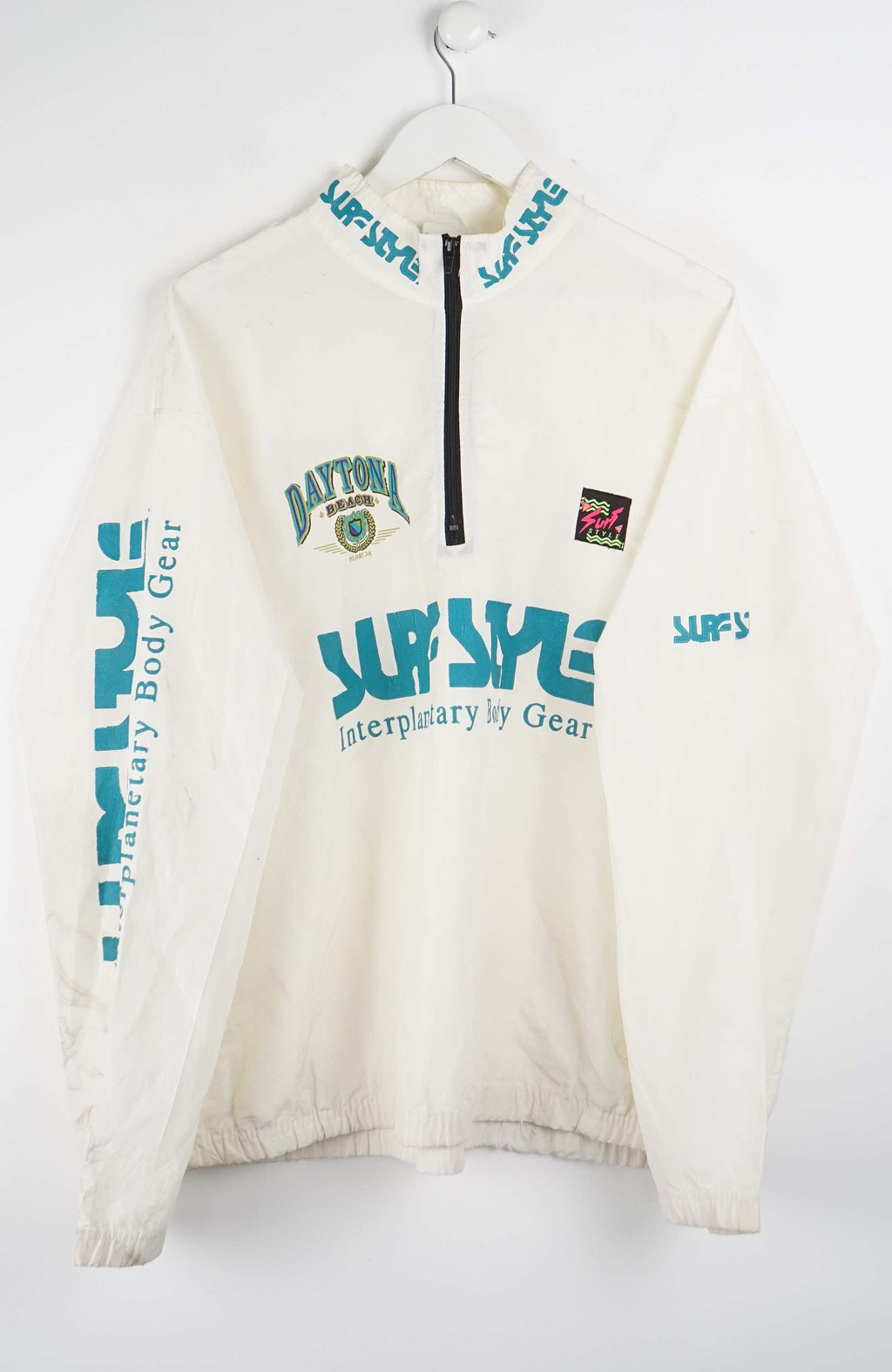White WINDBREAKER with blue and green text on a white background