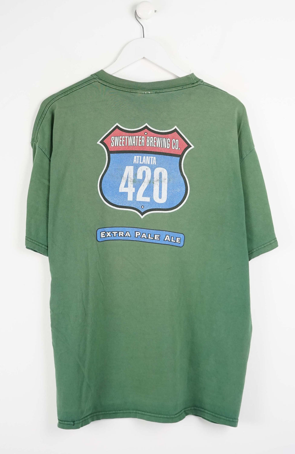 Green t-shirt with a logo on a white background
