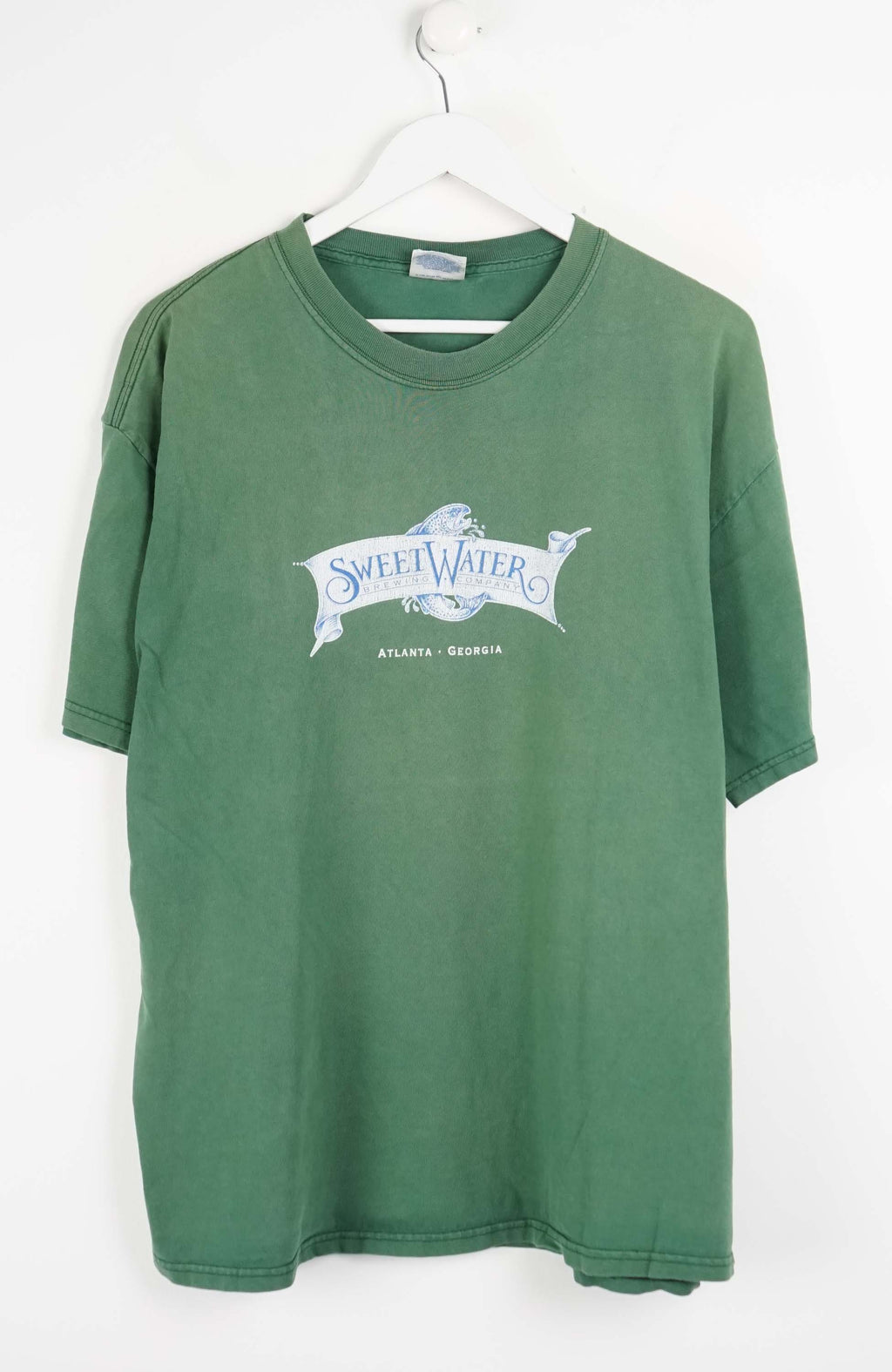 Green t-shirt with a logo on a white background