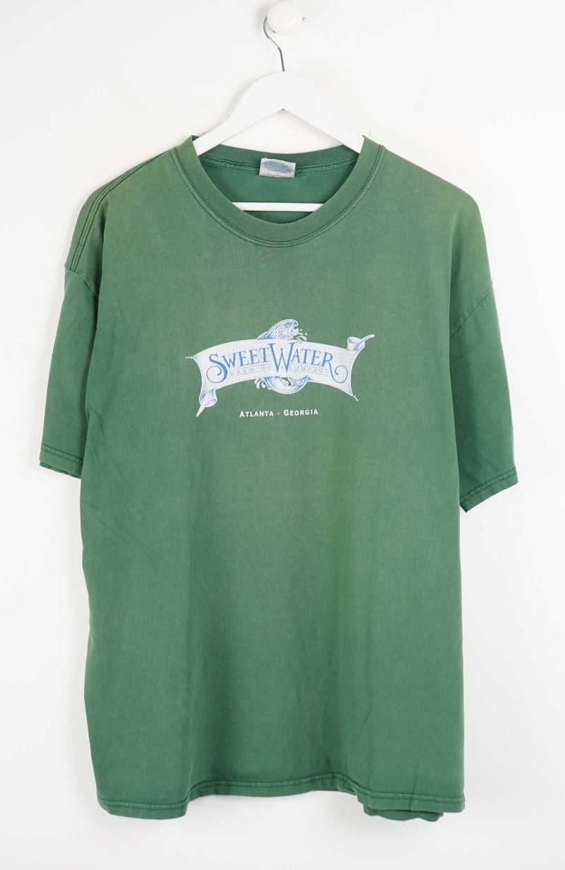 Green t-shirt with a logo on a white background
