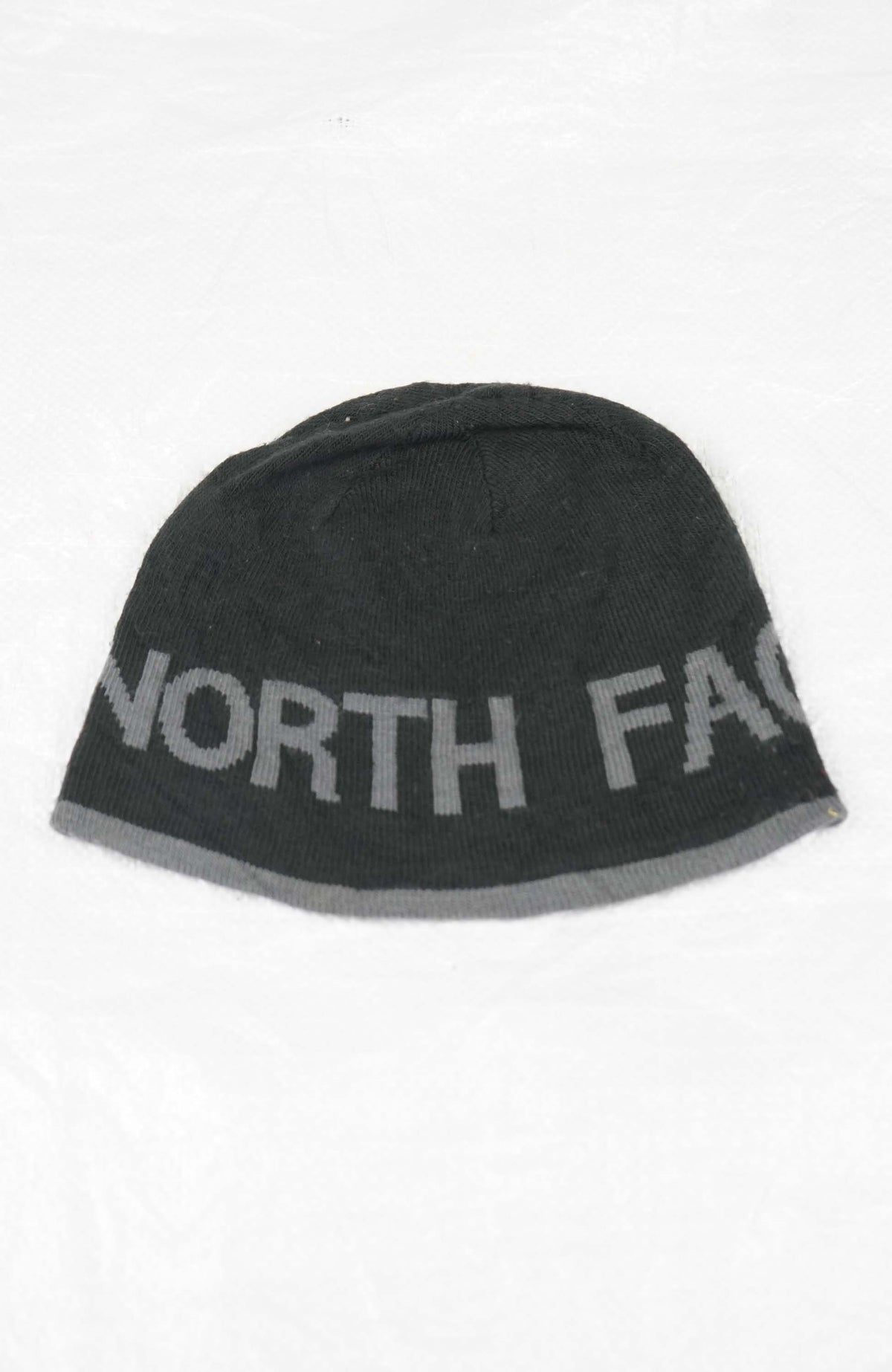 Gray beanie with 'The North Face' logo on a white background