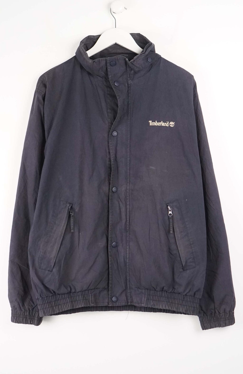 Dark jacket with Timberland logo on a white background
