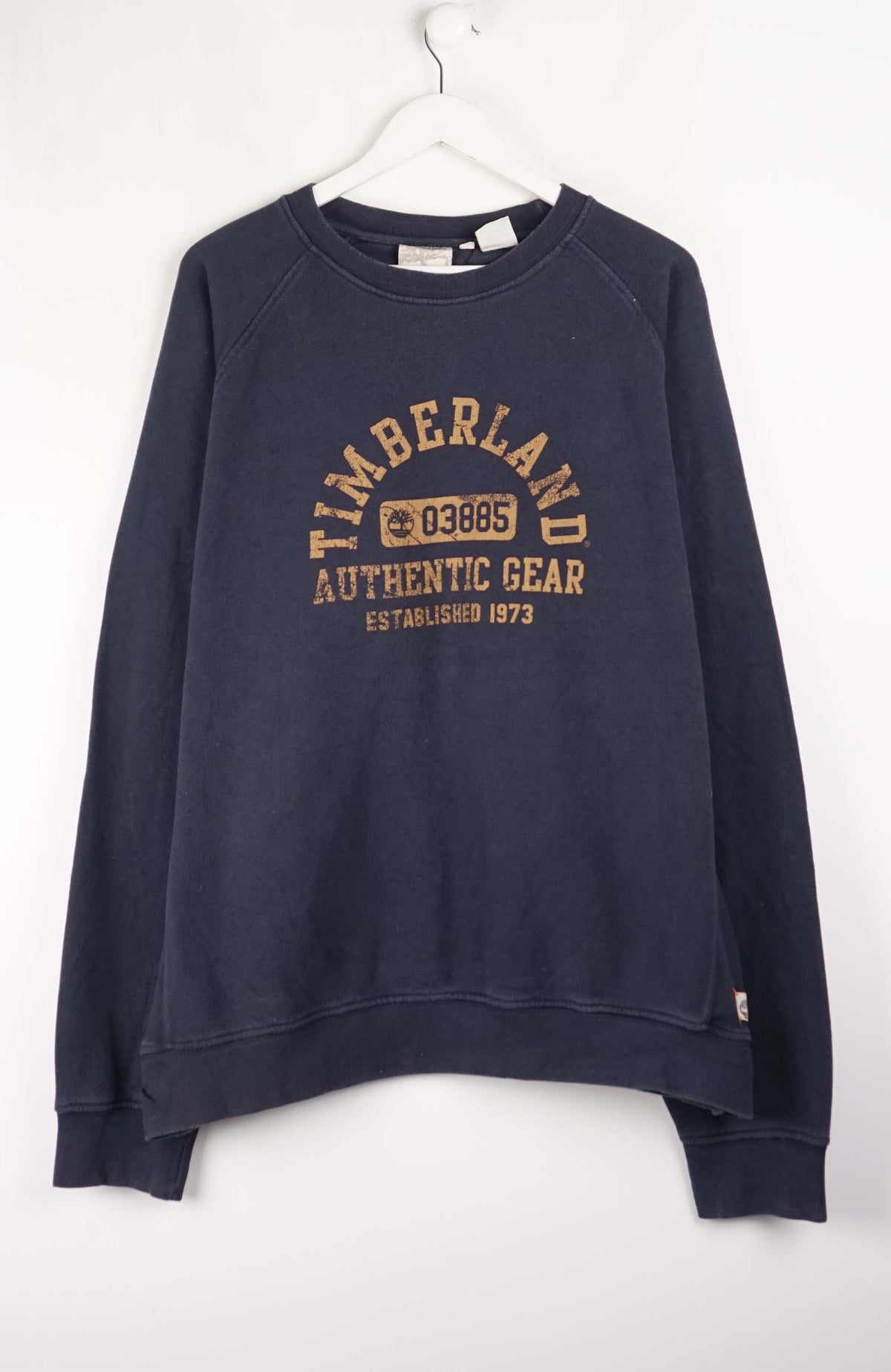Navy blue sweatshirt with Timberland logo on a white background