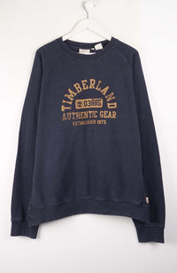 Navy blue sweatshirt with Timberland logo on a white background
