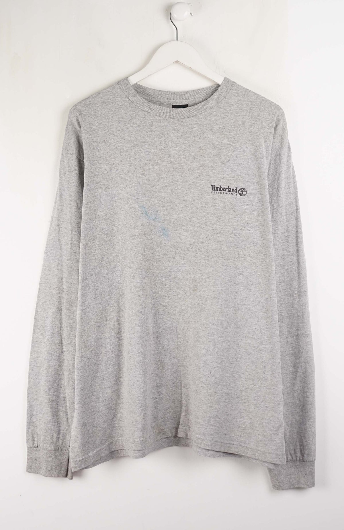Gray long-sleeve shirt with a small logo on a white hanger