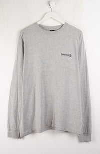 Gray long-sleeve shirt with a small logo on a white hanger
