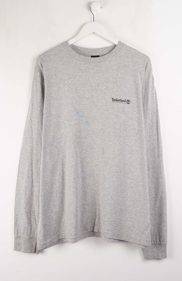 Gray long-sleeve shirt with a small logo on a white hanger