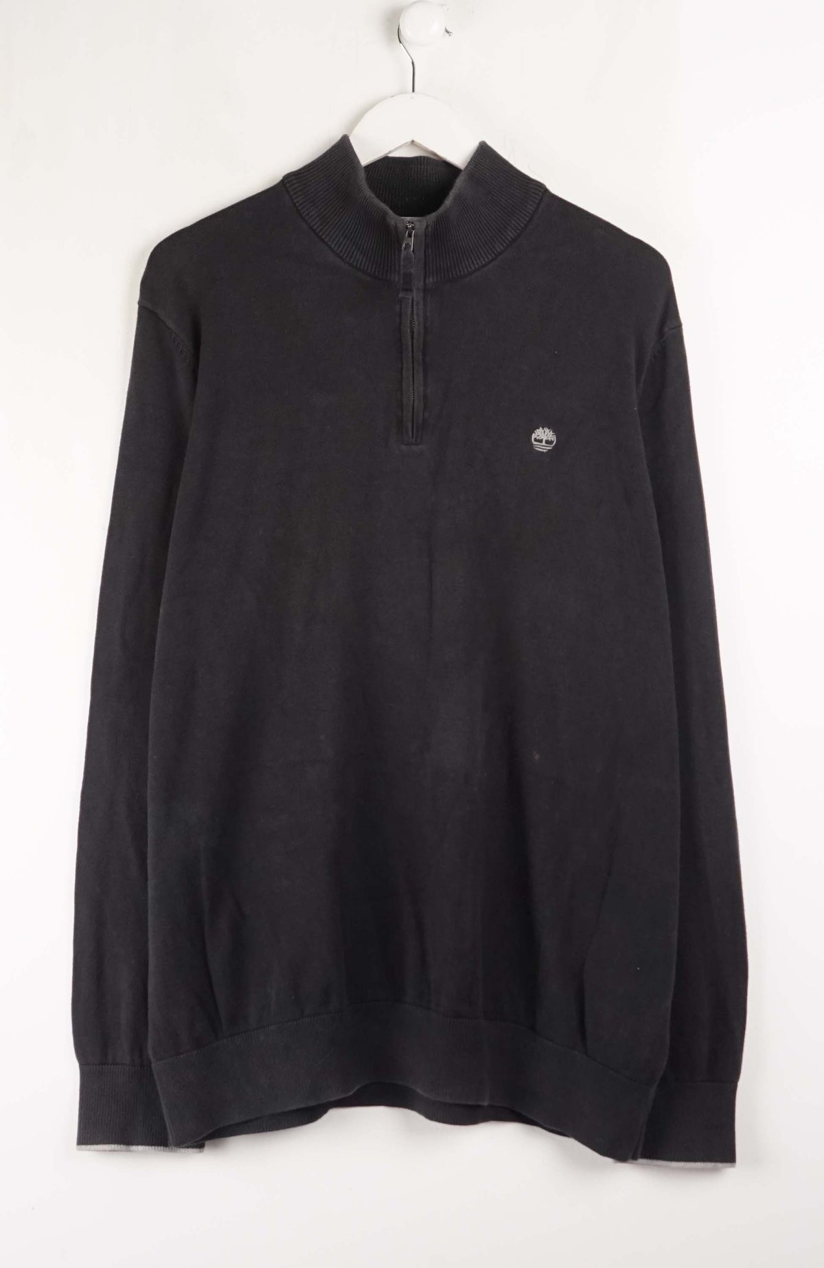 Black sweater with a logo on a white background