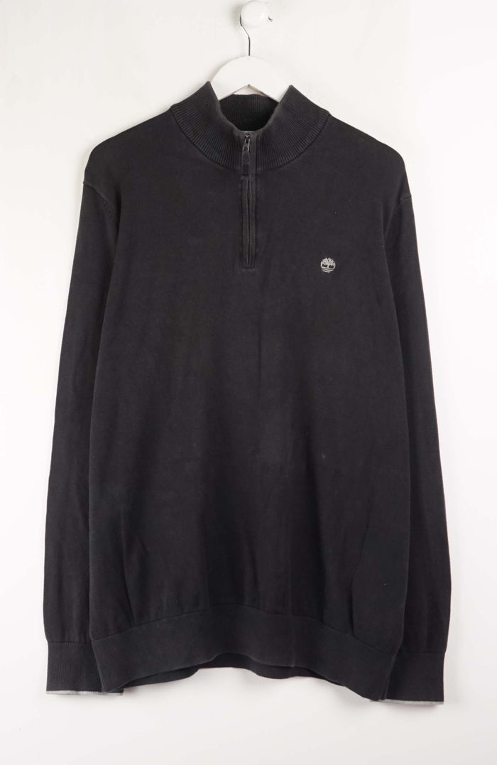 Black sweater with a logo on a white background
