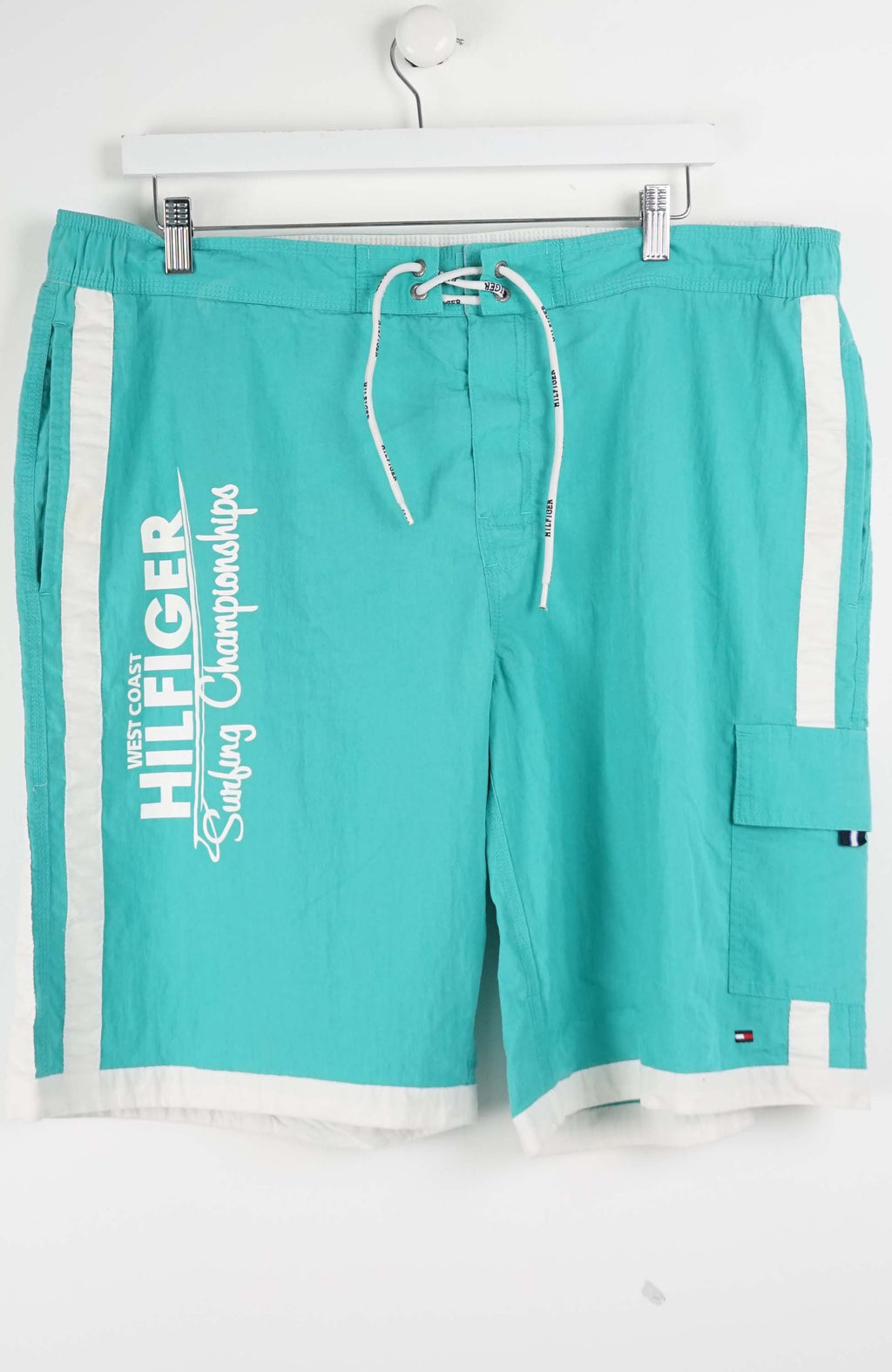 Turquoise shorts with white drawstring and side panels on a white background