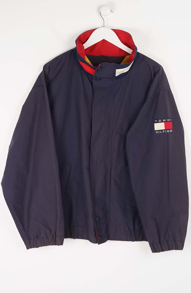 Navy blue jacket with Tommy Hilfiger logo on a white background