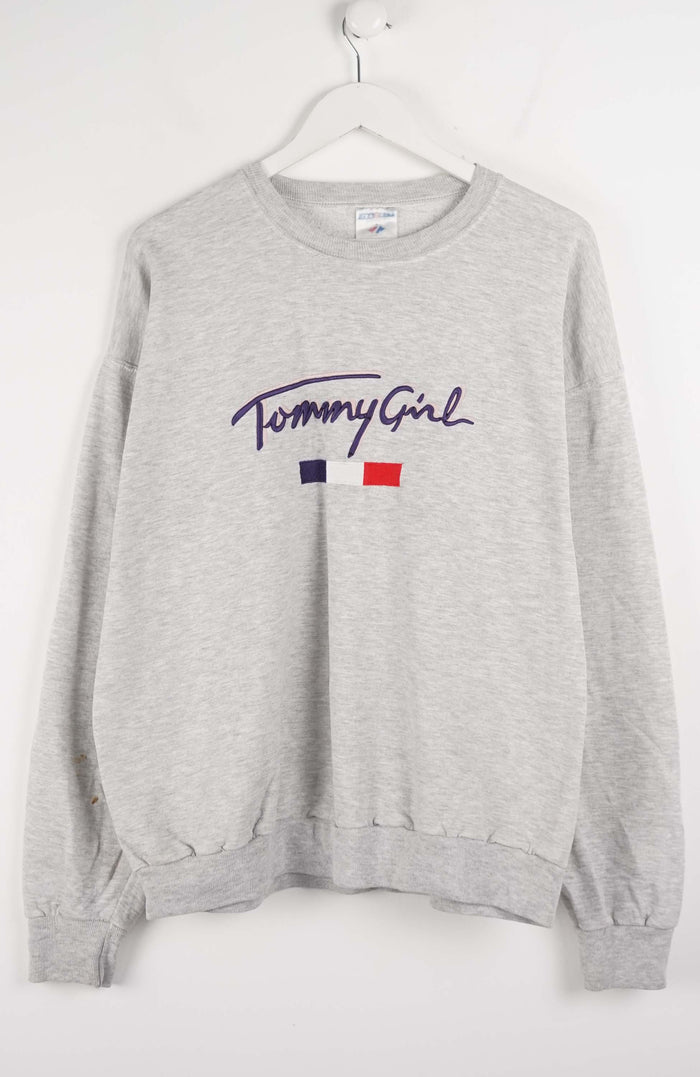 Gray sweatshirt with 'Tommy Girl' logo on a white background