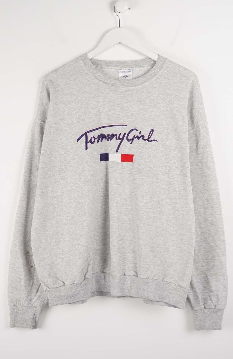 Gray sweatshirt with 'Tommy Girl' logo on a white background