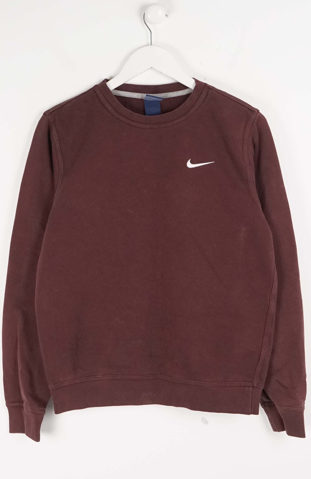 Brown sweatshirt with Nike logo on a white hanger