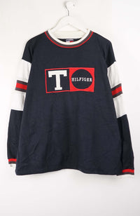 Navy long-sleeve shirt with red and white accents and Tommy Hilfiger logo on a white background
