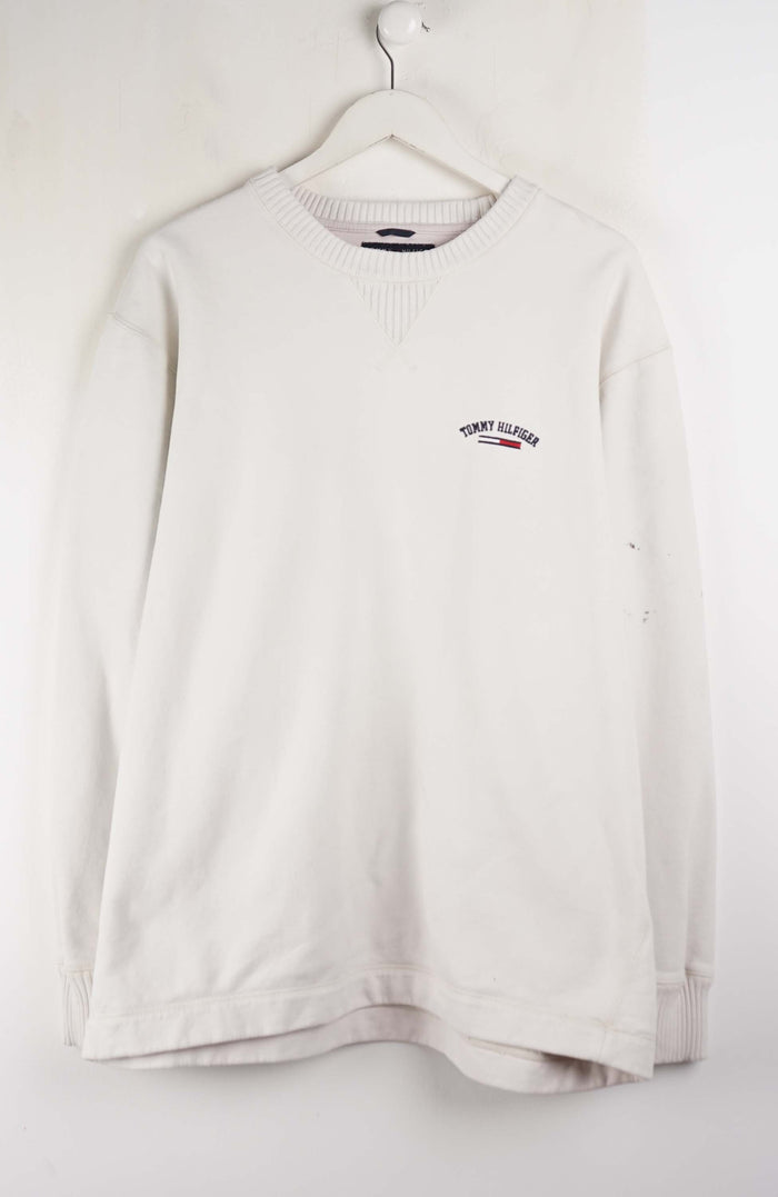 White long-sleeve shirt with a logo on a white background