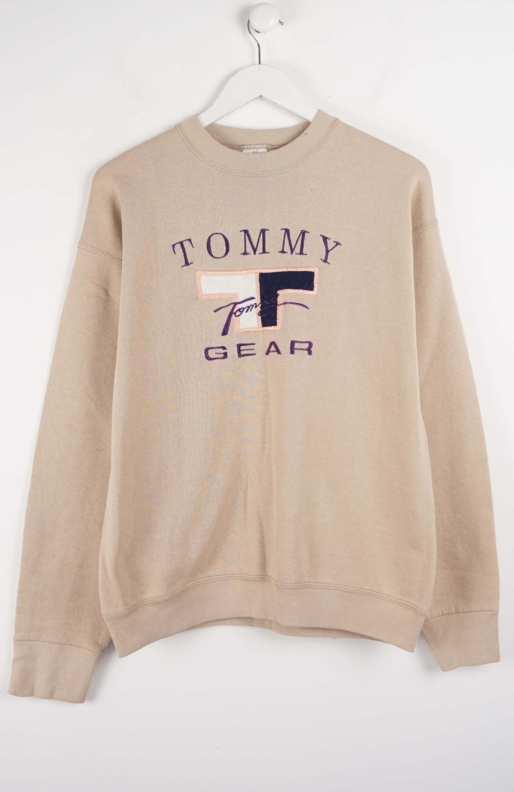 Beige sweatshirt with Tommy Gear logo on a white background