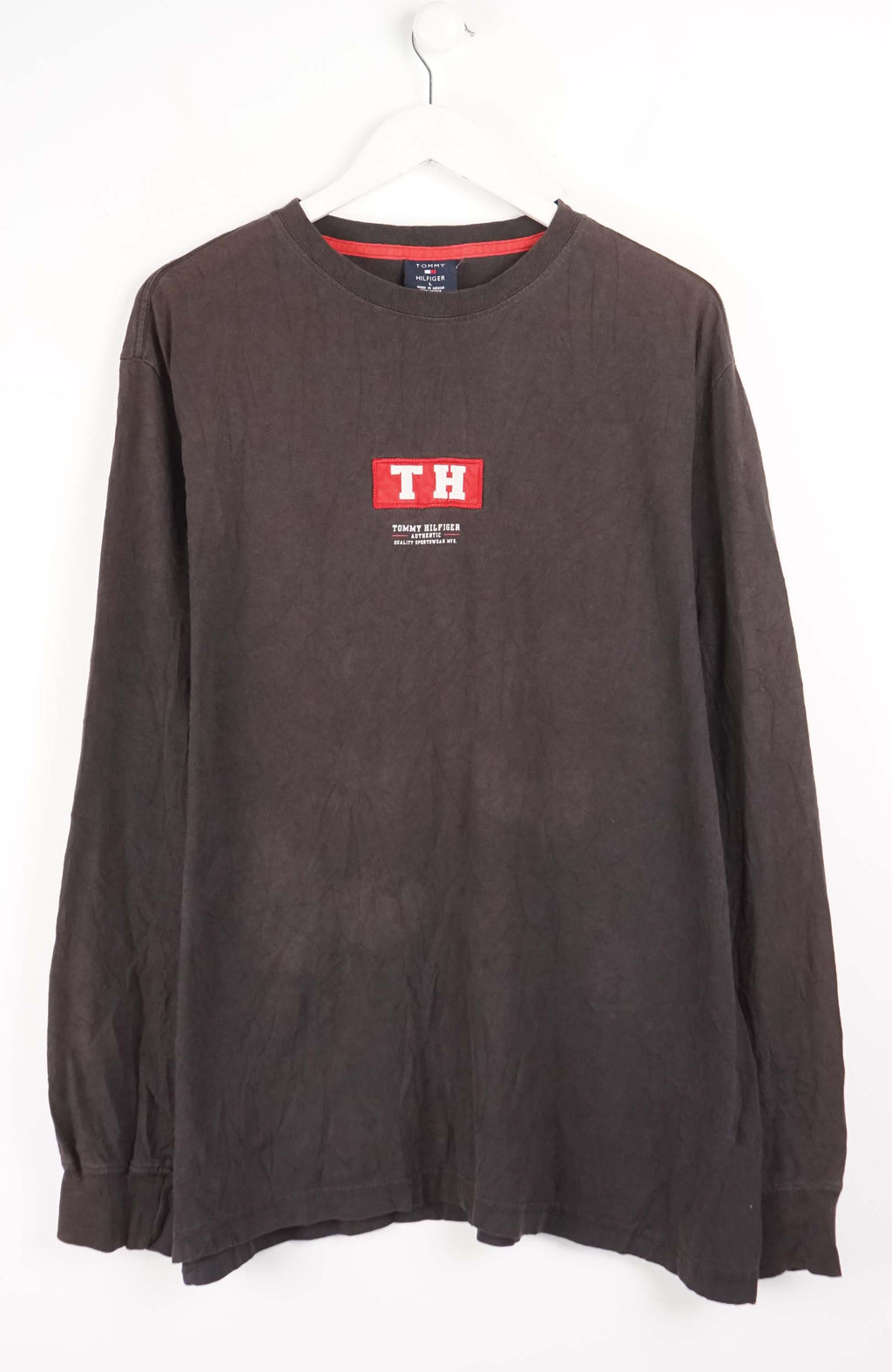 Brown long-sleeve shirt with a logo on a white background