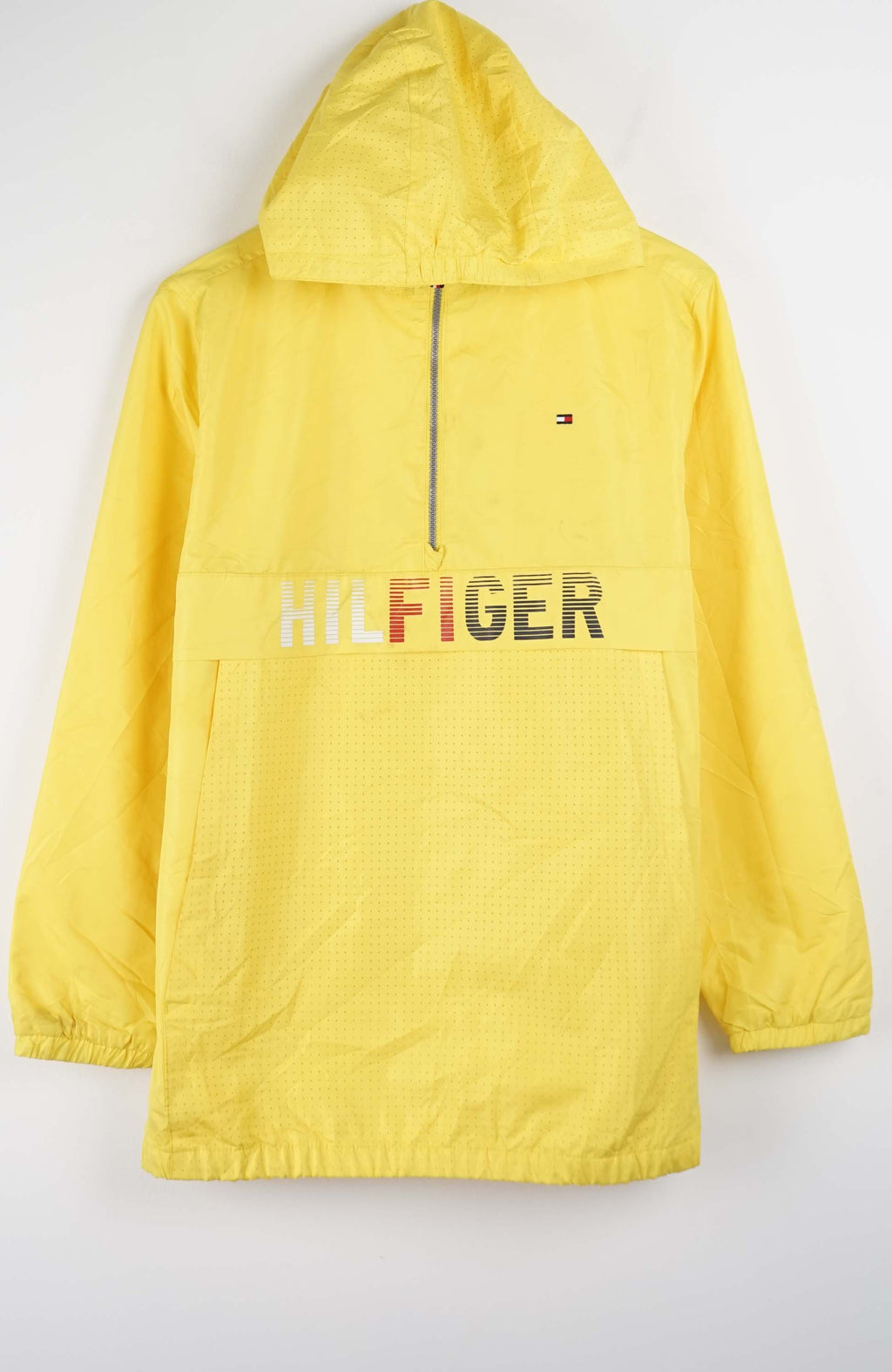 Yellow jacket with 'Tommy Hilfiger' logo on a white background