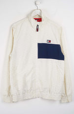 White jacket with a navy pocket on a white background