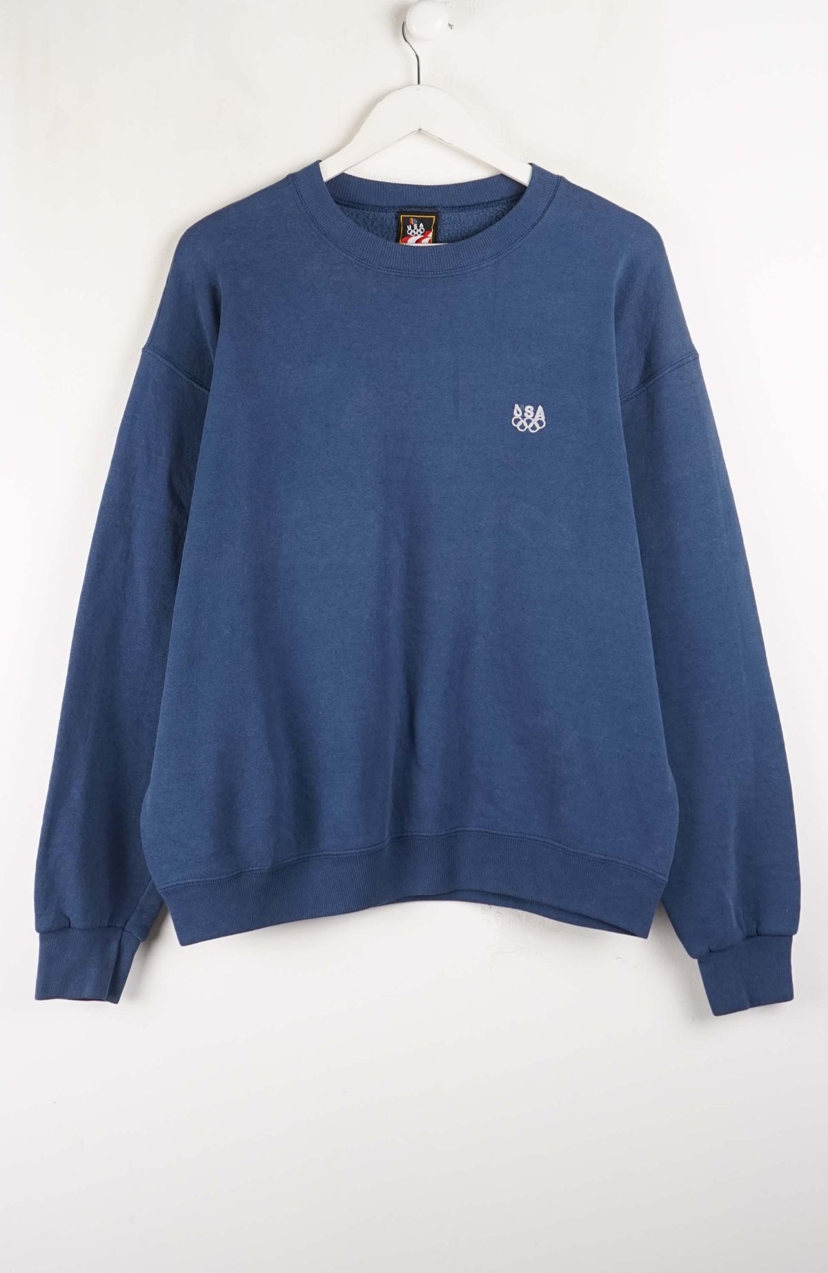 Blue sweatshirt with a small logo on a white background