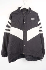 Black and white jacket with striped sleeves on a hanger against a white background