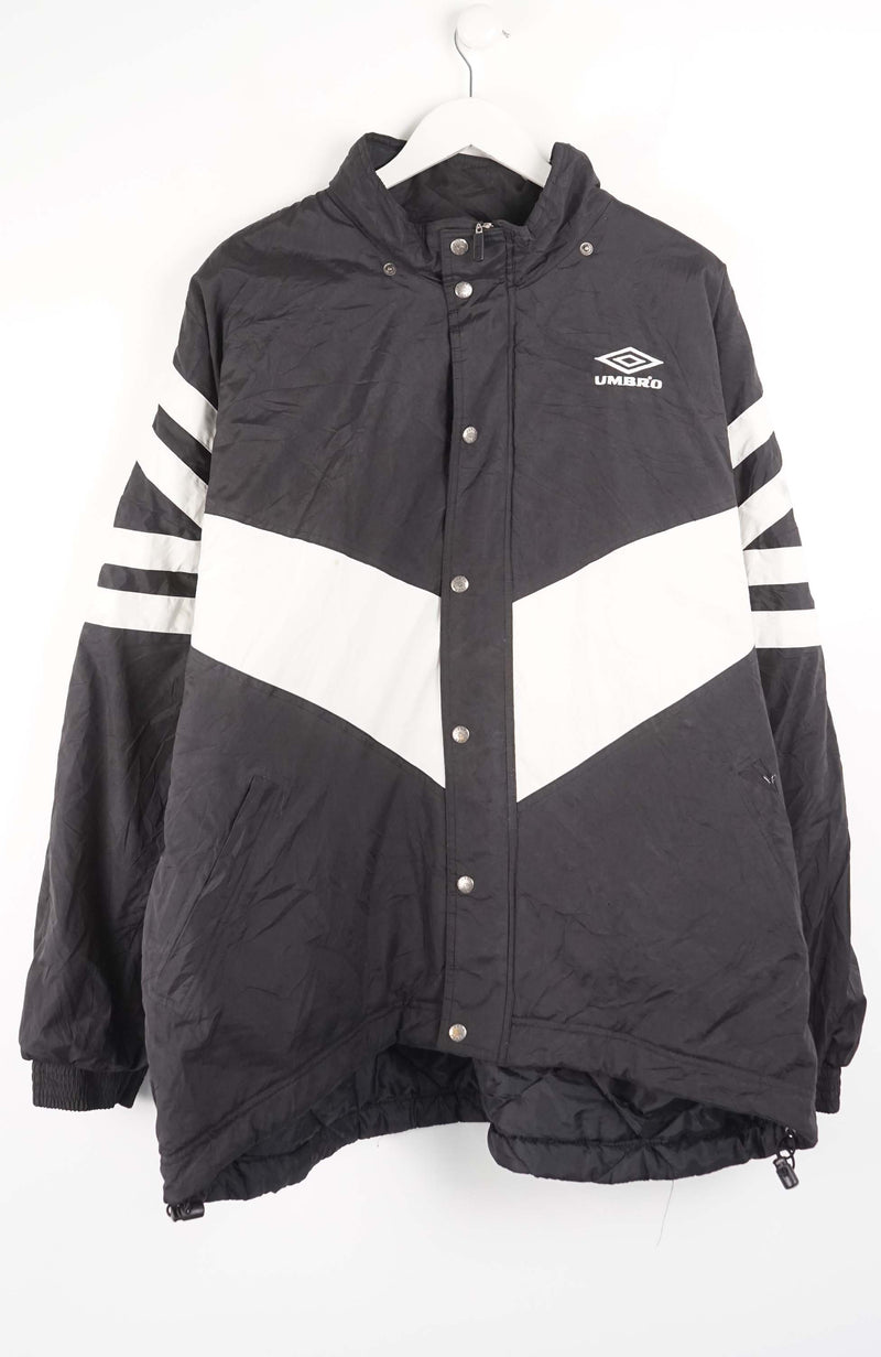 Black and white jacket with striped sleeves on a hanger against a white background