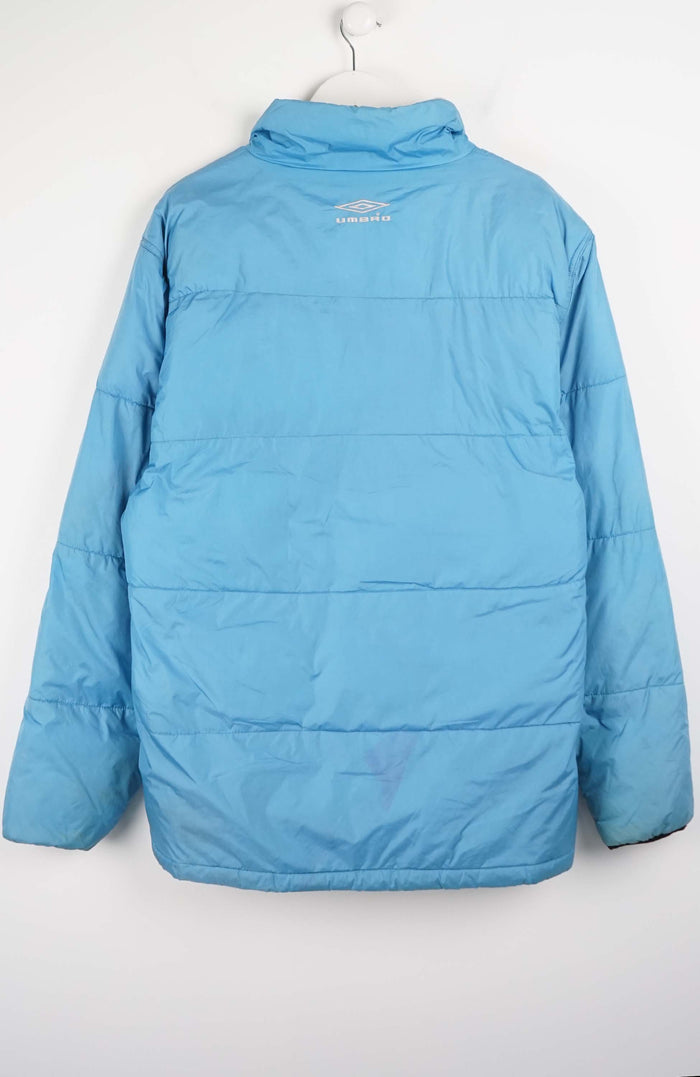 Blue puffer jacket on a white hanger against a white background