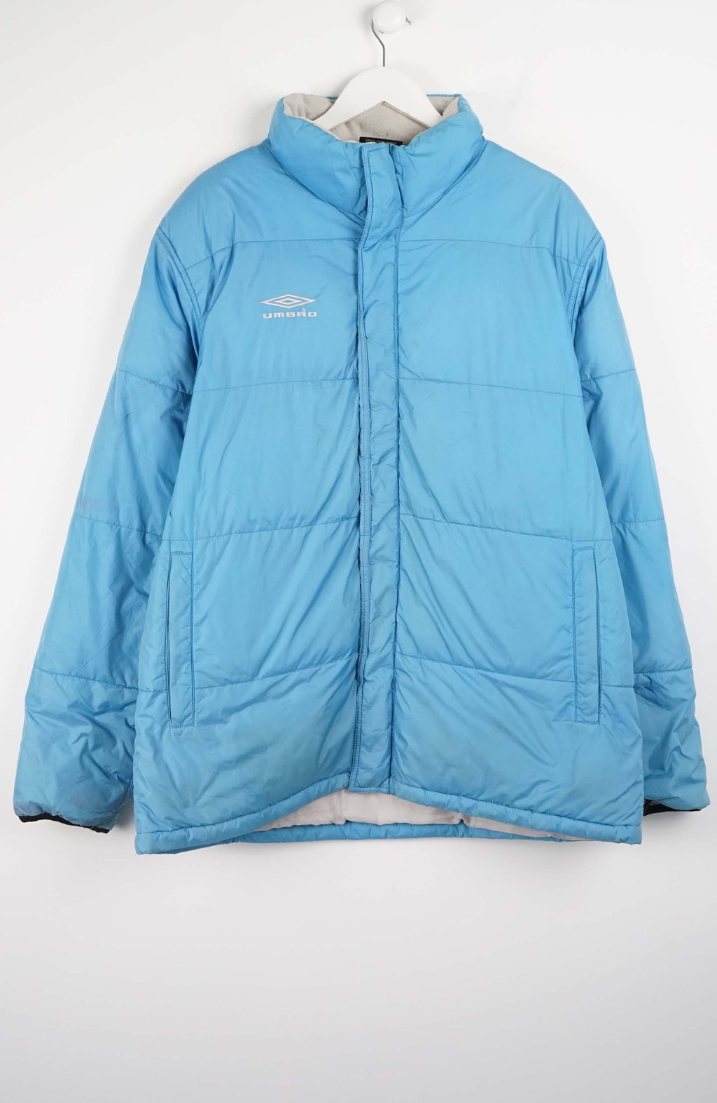 Blue puffer jacket on a white background